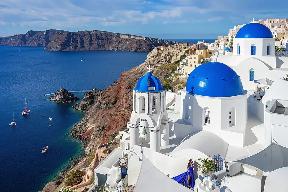 Oia’s white houses and blue domes above the Santorini caldera