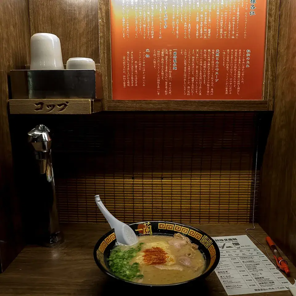 A bowl of ramen in a solo booth at Ichiran’s Shibuya store