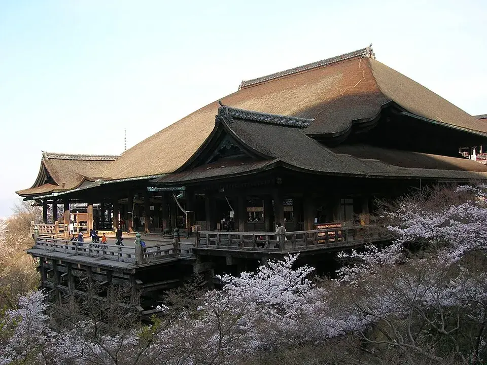 Kiyomizu-dera’s wooden stage and hall above cherry trees in blossom