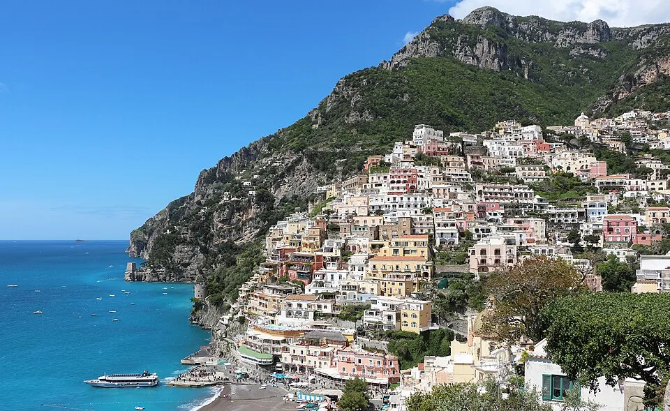 Positano’s pastel houses stacked on the cliff above the sea